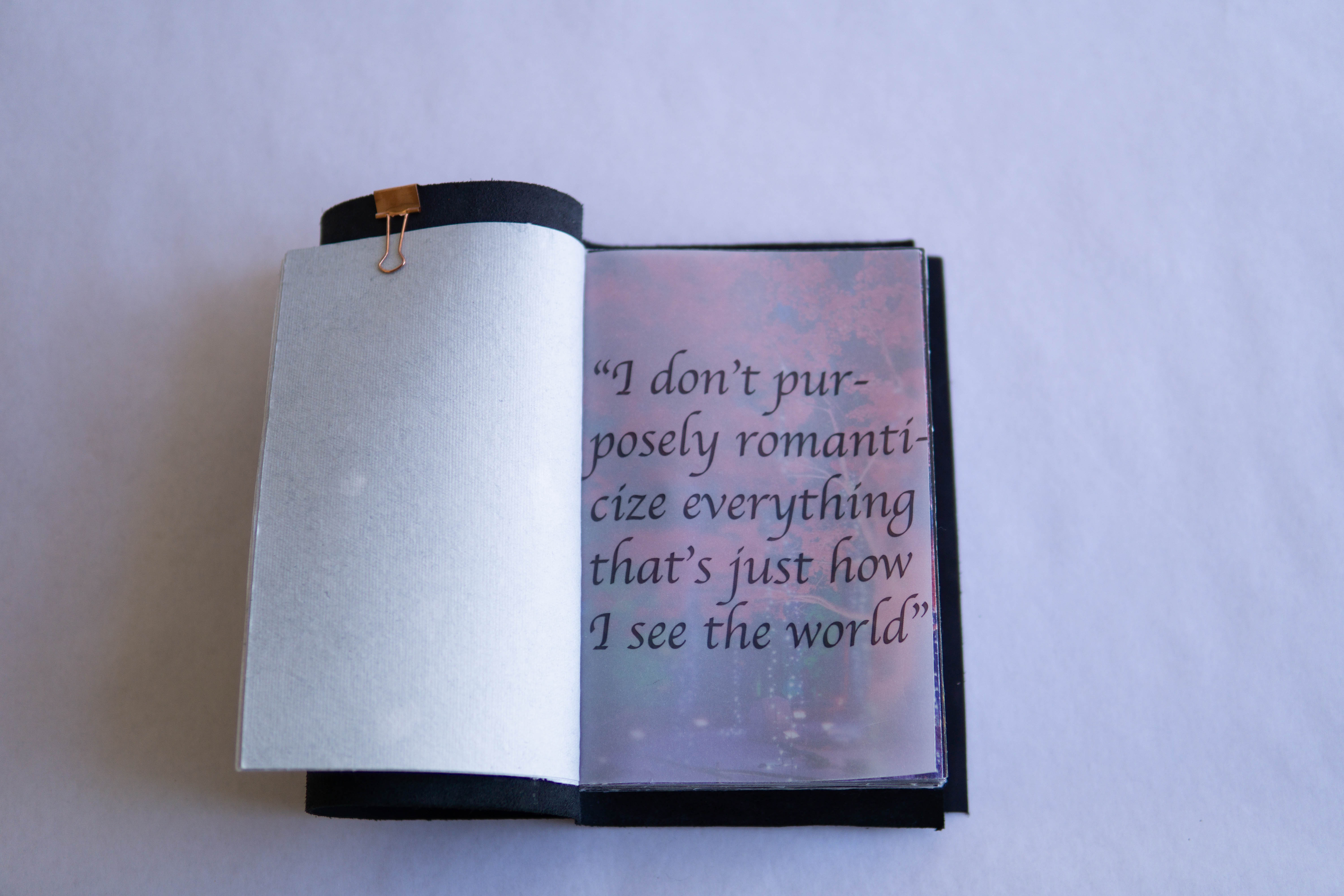Layered vellum page revealing a quote beneath, demonstrating transparency and depth in the book's material design